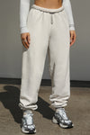 Front view of model from the waist down wearing the oversized loose fit sahara french terry Oversized Jogger with an elastic waistband and ankle cuffs