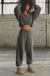 Full body front view of model posing in the oversized loose fit washed black french terry Oversized Jogger with an elastic waistband and ankle cuffs