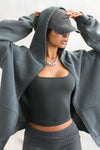 Front view of model posing in the oversized comfortable evergreen french terry Oversized Zip Hoodie with a full length front zip closure, side pockets and thumbholes in the fitted cuffs