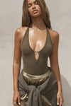Front view of model posing in the fitted woodland flexrib Plunge Racerback Tank top with a plunging neckline and  a strappy bust detail.