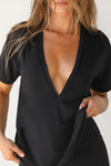 Close up front view of model posing in the full length relaxed fit black modal Plunge V Neck Tee with an plunging v-neckline