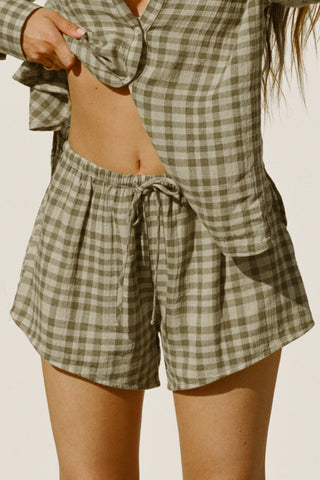 Close up front view of model from the waist down posing in the relaxed fit lightweight orchard gauze Relaxed Everyday Short with an elastic waistband and adjustable front tie