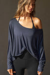 Front view of model posing in the full-length navy modal Relaxed Long Sleeve top with dropped shoulders and a wide neckline that can be worn off the shoulders.