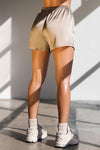 Back view of model from the waist down posing in the comfortable, boxer-style fawn Relaxed Silk Short with an elastic waistband
