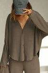 Front view of model posing in the relaxed-fit, long sleeve army luxe knit Relaxed V-Neck Cardigan with front button closures and a V-neckline.