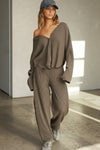 Full body front view of model posing in the relaxed-fit, long sleeve army luxe knit Relaxed V-Neck Cardigan with front button closures and a V-neckline.