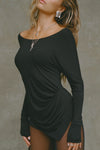 Side view of model posing in soft and lightweight black modal Ruched Asymmetrical Long Sleeve top with fitted sleeves, a relaxed asymmetrical hemline and a flattering ruched side detail