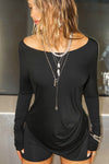 Front view of model posing in soft and lightweight black modal Ruched Asymmetrical Long Sleeve top with fitted sleeves, a relaxed asymmetrical hemline and a flattering ruched side detail