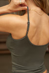 Close up detail back view of model posing in the fitted spruce modal Scoop Neck Cami with thin adjustable straps, scoop neckline and scoop back