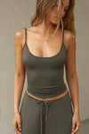 Front view of model posing in the fitted spruce modal Scoop Neck Cami with thin adjustable straps, scoop neckline and scoop back
