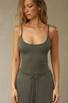 Front view of model posing in the fitted spruce modal Scoop Neck Cami with thin adjustable straps, scoop neckline and scoop back