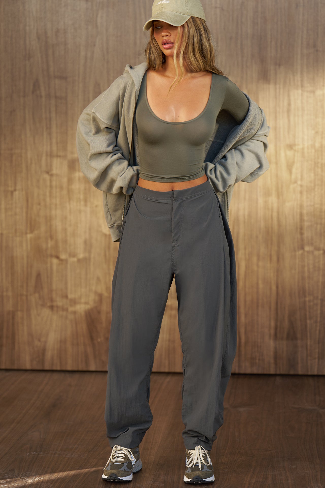 Full body front view of model posing in the fitted lightweight spruce modal Scoop Neck Long Sleeve top with a deep scoop neckline and fitted sleeves