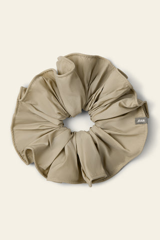 Flat lay view of the oversized  desert sage Nylon Scrunchie with a voluminous silhouette