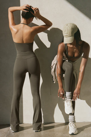 Two models posing in sueded carob top and legging sets