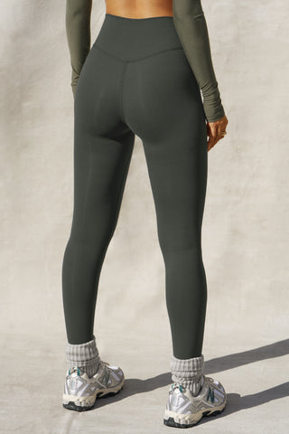 Back view of model from the waist down posing in the full length and high-waisted sueded essex Second Skin Legging with a wide, v-shaped waistband