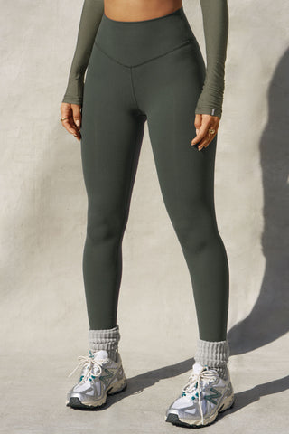 Front view of model from the waist down posing in the full length and high-waisted sueded essex Second Skin Legging with a wide, v-shaped waistband