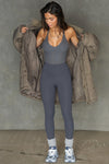 Full body front view of model posing the full length and high-waisted sueded navy Second Skin Legging with a wide, v-shaped waistband
