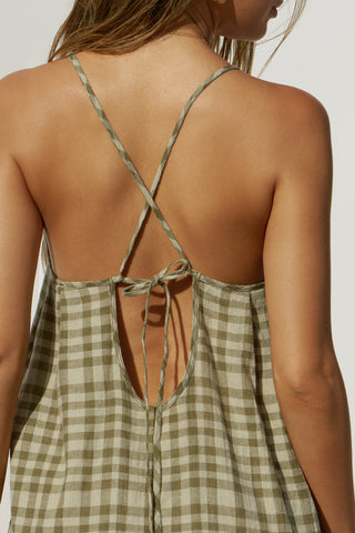 Close up back view of model posing in the lightweight orchard gauze Shift Mini Dress with a scoop neckline, front keyhole detail and open back with adjustable straps and a tie closure