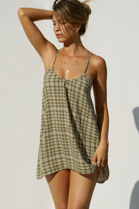 Front view of model posing in the lightweight orchard gauze Shift Mini Dress with a scoop neckline, front keyhole detail and open back with adjustable straps and a tie closure