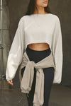 Front view of model posing in the cropped relaxed fit fog cotton Slouchy Crop Long Sleeve top with a crew neckline, dropped shoulders and oversized sleeves