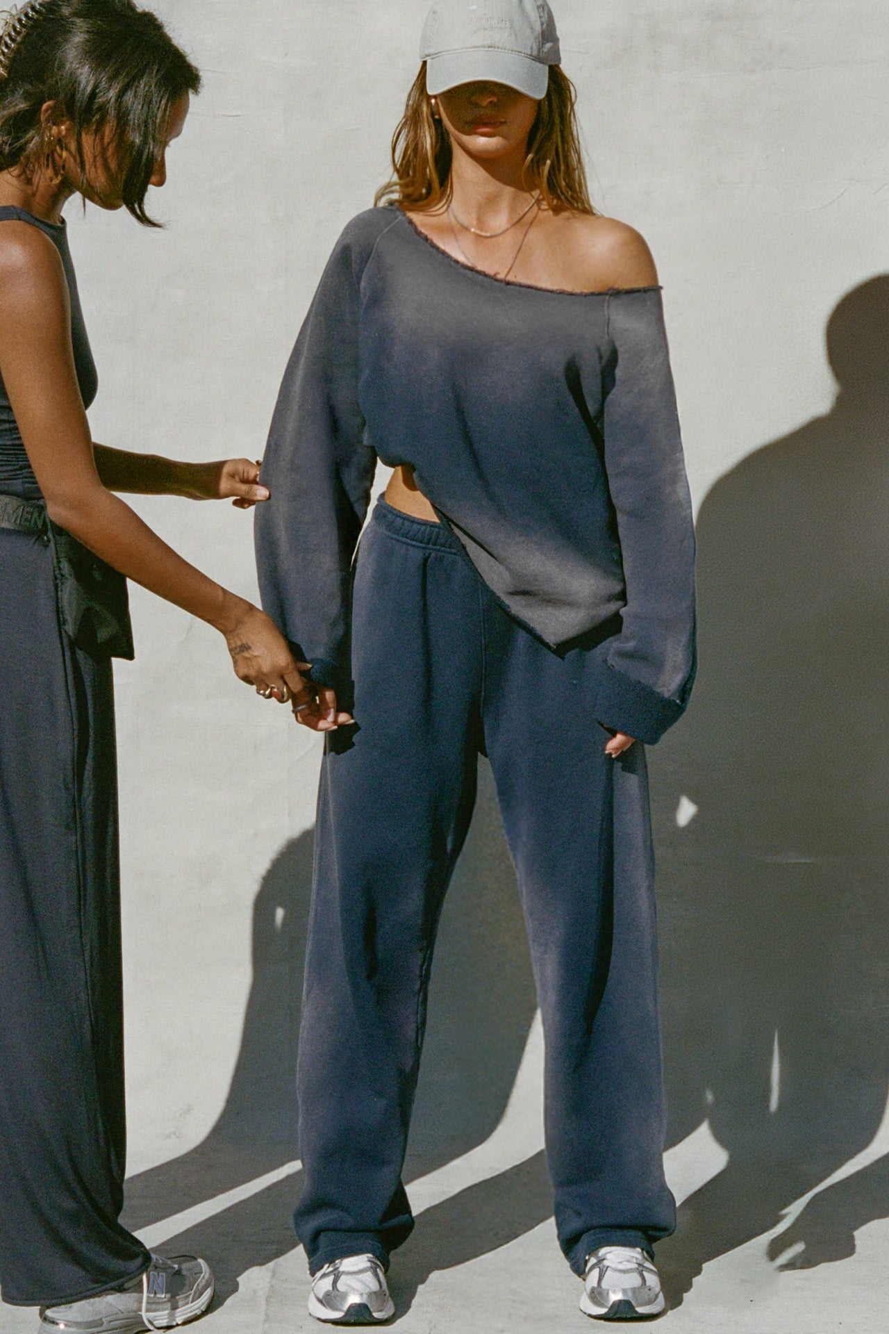 Full body front view of model posing in the oversized heritage washed navy french terry Slouchy Pullover Sweatshirt with a wide, off-the-shoulder neckline and a JOAH BROWN logo patch on the right sleeve