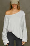 Front view of model posing in the oversized pearl grey french terry Slouchy Pullover Sweatshirt with a wide, off-the-shoulder neckline and a JOAH BROWN logo patch on the right sleeve