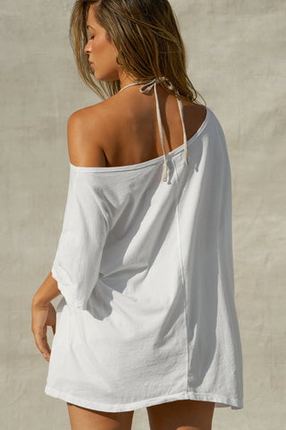 Back view of model posing in the oversized optic white classic cotton Slouchy Tunic Tee with a wide scoop neckline that can be worn off the shoulder