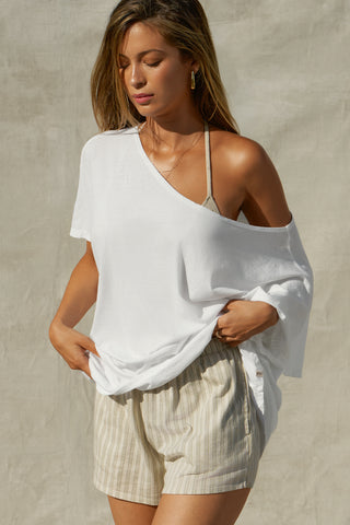 Front view of model posing in the oversized optic white classic cotton Slouchy Tunic Tee with a wide scoop neckline that can be worn off the shoulder
