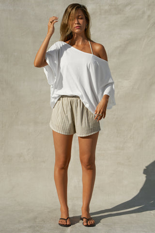 Full body front view of model posing in the oversized optic white classic cotton Slouchy Tunic Tee with a wide scoop neckline that can be worn off the shoulder