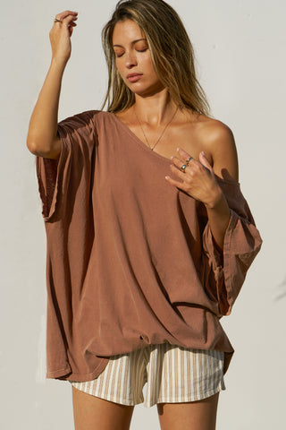 Front view of model posing in the oversized tobacco classic cotton Slouchy Tunic Tee with a wide scoop neckline that can be worn off the shoulder