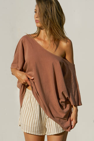 Front view of model posing in the oversized tobacco classic cotton Slouchy Tunic Tee with a wide scoop neckline that can be worn off the shoulder
