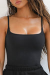 Close up front view of model posing in the soft and stretchy sueded onyx Smoothing Cami with a scoop neckline and thin straps