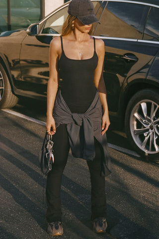 Full body front view of model posing in the soft and stretchy sueded onyx Smoothing Cami with a scoop neckline and thin straps
