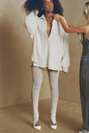 Full body front view of model posing in the sheer high-waisted porcelain mesh Split Hem Legging with gathered ankles, exposed seams and button closures at the leg opening
