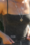 Close up detail front view of model posing outside in the semi-fitted charcoal washed rib Square Neck Cami with thin, wide-set straps and a clean, straight neckline.
