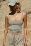 Front view of model posing outside in the semi-fitted dune washed rib Square Neck Cami with thin, wide-set straps and a clean, straight neckline.