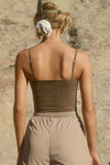 Back view of model posing in the semi-fitted sepia washed rib Square Neck Cami with thin, wide-set straps and a clean, straight neckline.