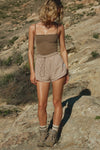 Full body front view of model posing in the semi-fitted sepia washed rib Square Neck Cami with thin, wide-set straps and a clean, straight neckline.