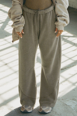 Front view of model from the waist down posing in the relaxed-fit oakmoss sherpa Straight Leg Sweatpant with a straight-leg silhouette, elastic waistband, side pockets, curved seam details and a JOAH BROWN logo patch