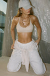 Front view of model posing in the sporty sueded yuma T-Back Bra with a scoop neckline, open T-back and adjustable straps.