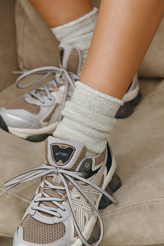 Close up front view of model wearing the soft heathered grey Terry Crew Sock with a rolled top