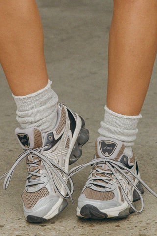 Close up front view of model wearing the soft heathered grey Terry Crew Sock with a rolled top