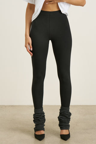 Front view of model from the waist down posing in the sleek and stretchy full length sueded onyx The Body Legging with a mid-rise elastic waistband