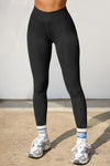Front view of model from the waist down wearing the sleek and stretchy full length sueded onyx The Body Legging with a mid-rise elastic waistband