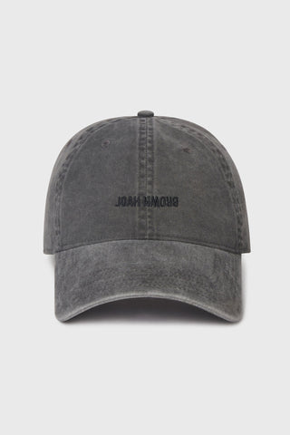 Flat lay front view of the six-panel washed black Official Cap with a curved brim and an embroidered upside down Joah Brown logo on the front