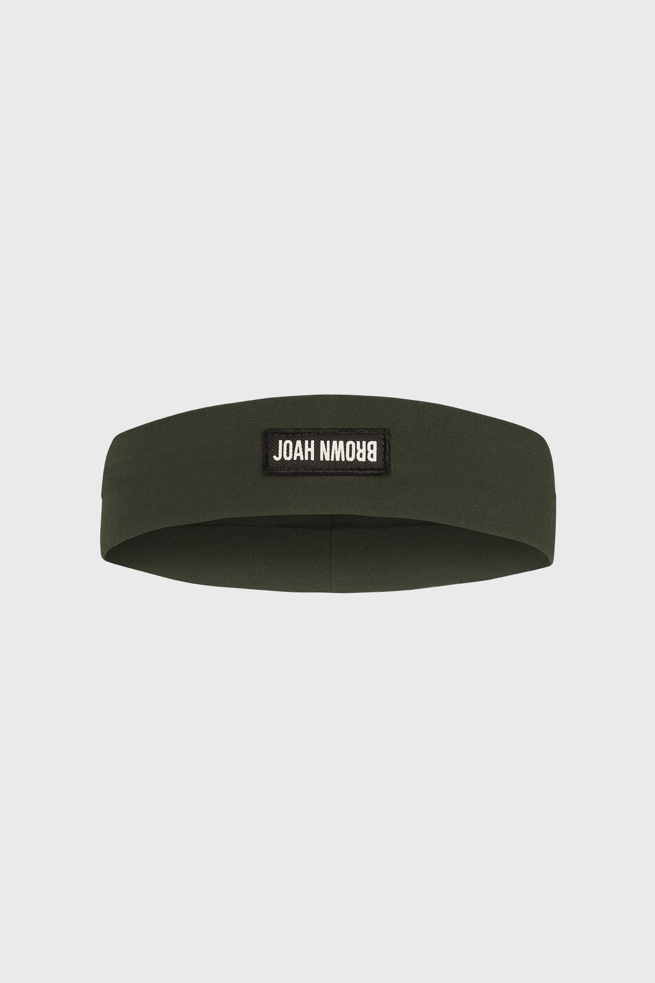 Flat lay front view of the stretchy wide sueded essex Classic Headband with a Joah Brown logo patch on the front