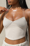 Close up front view of model posing in the fitted cropped sueded yuma Tri-Layer Corset with multi-layered bust accents of three different fabrics and ultra thin corded straps