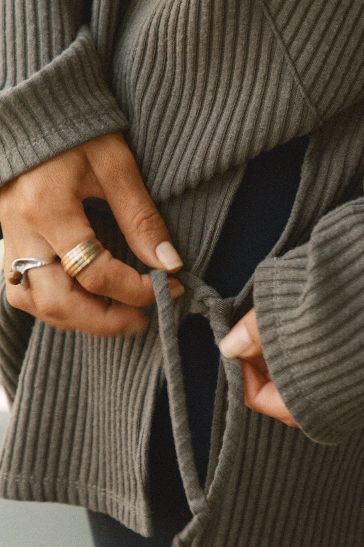 Close up detail view of the side slits and adjustable ties of the relaxed and slouchy tunic-style army luxe knit Turtleneck Tunic 