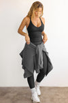 Full body front view of model posing in the fitted stretchy black flexrib V Neck Racerback Tank with a v neckline and thin straps