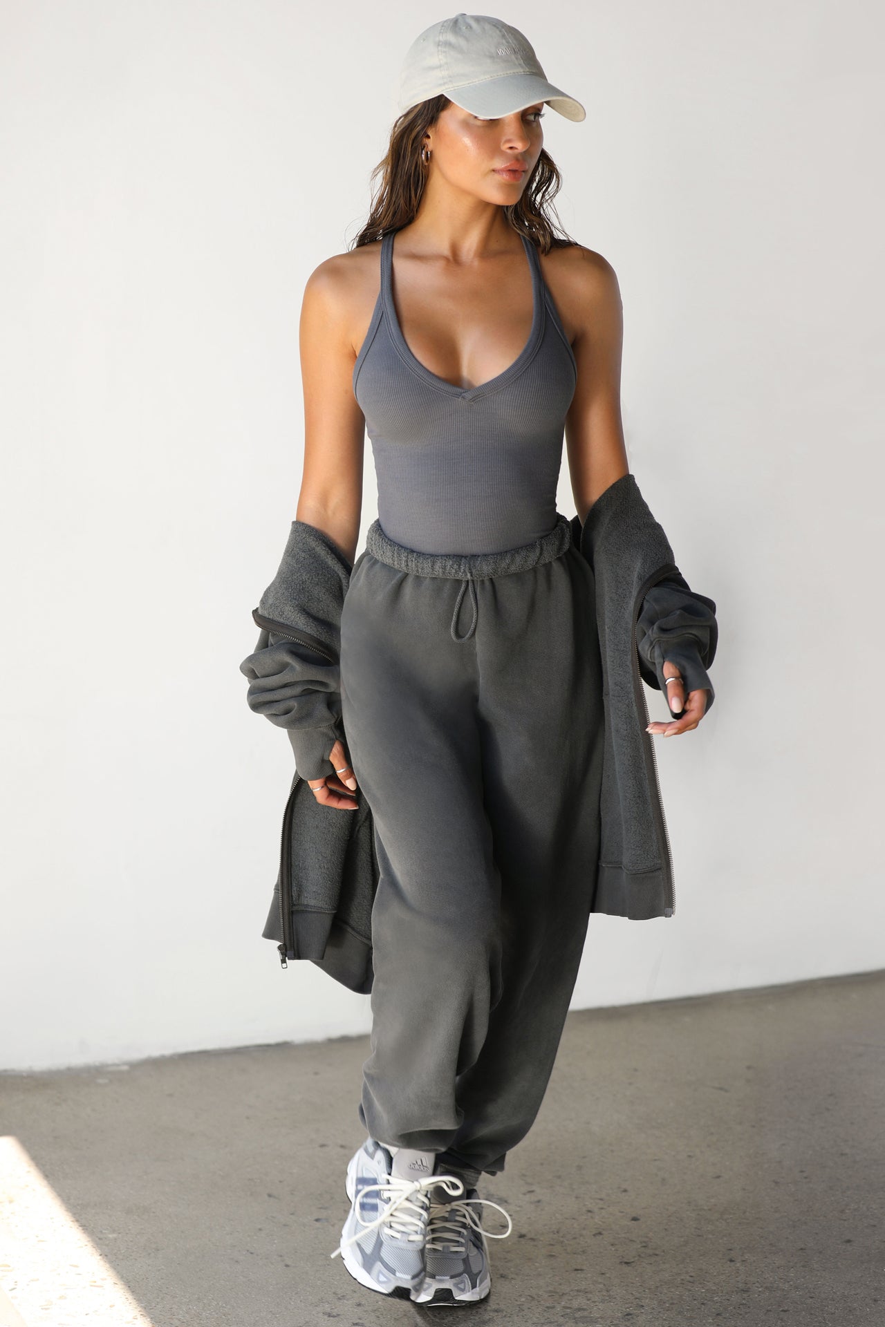 Full body front view of model posing in the fitted stretchy amoke flexrib V Neck Racerback Tank with a v neckline and thin straps